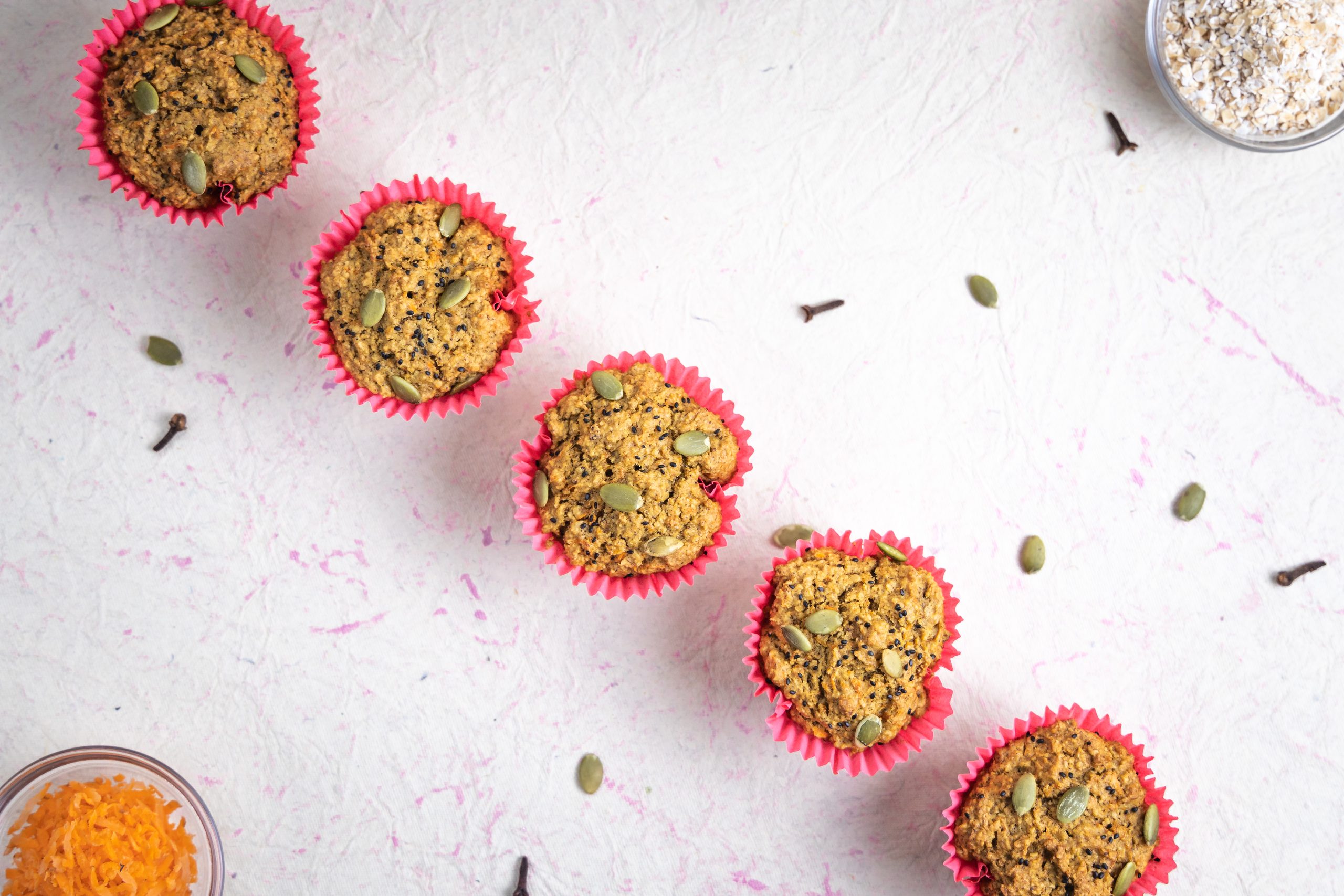 Overhead flatlay of muffins in pink cases