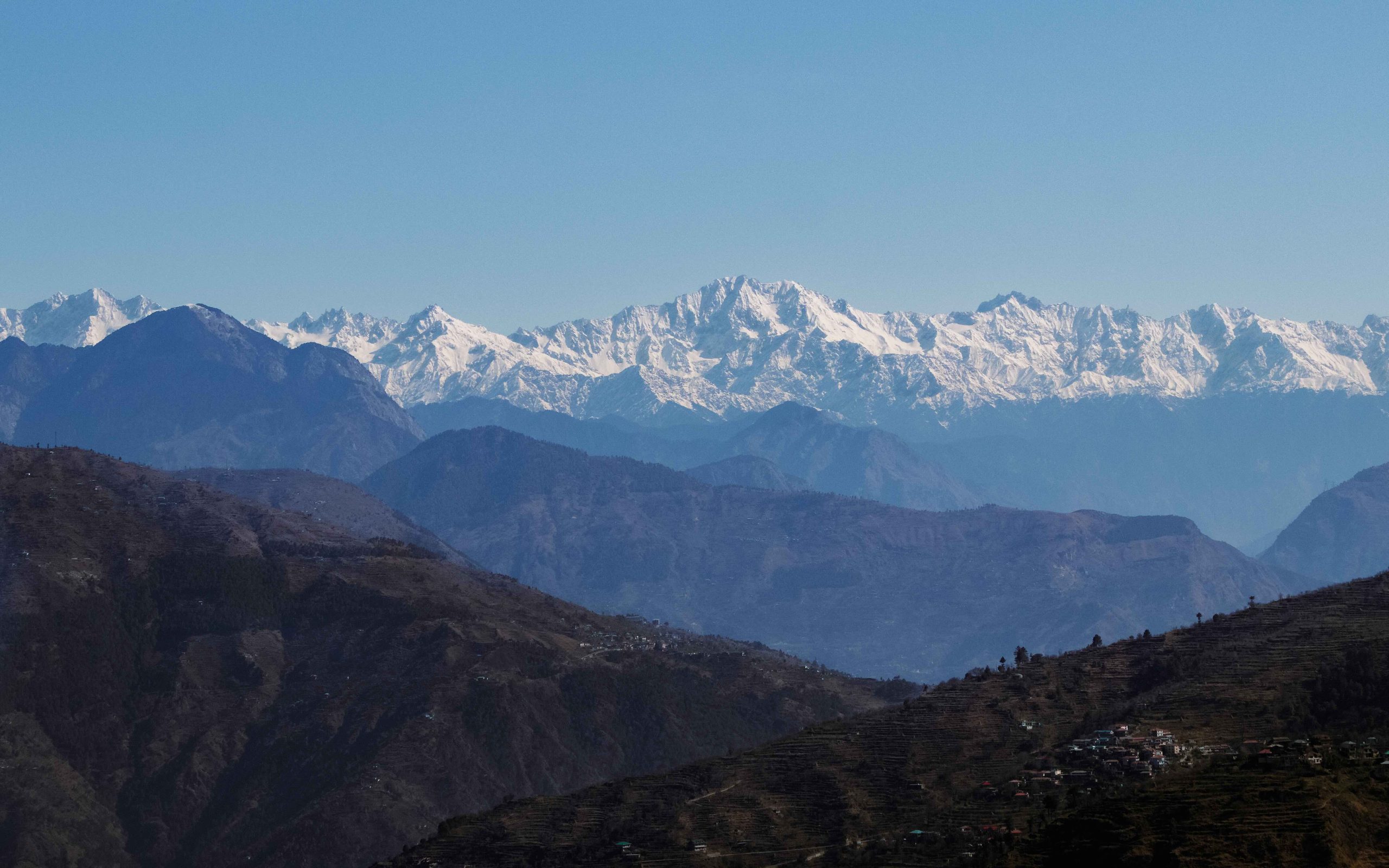 Layered blue ridgelines receding into haze