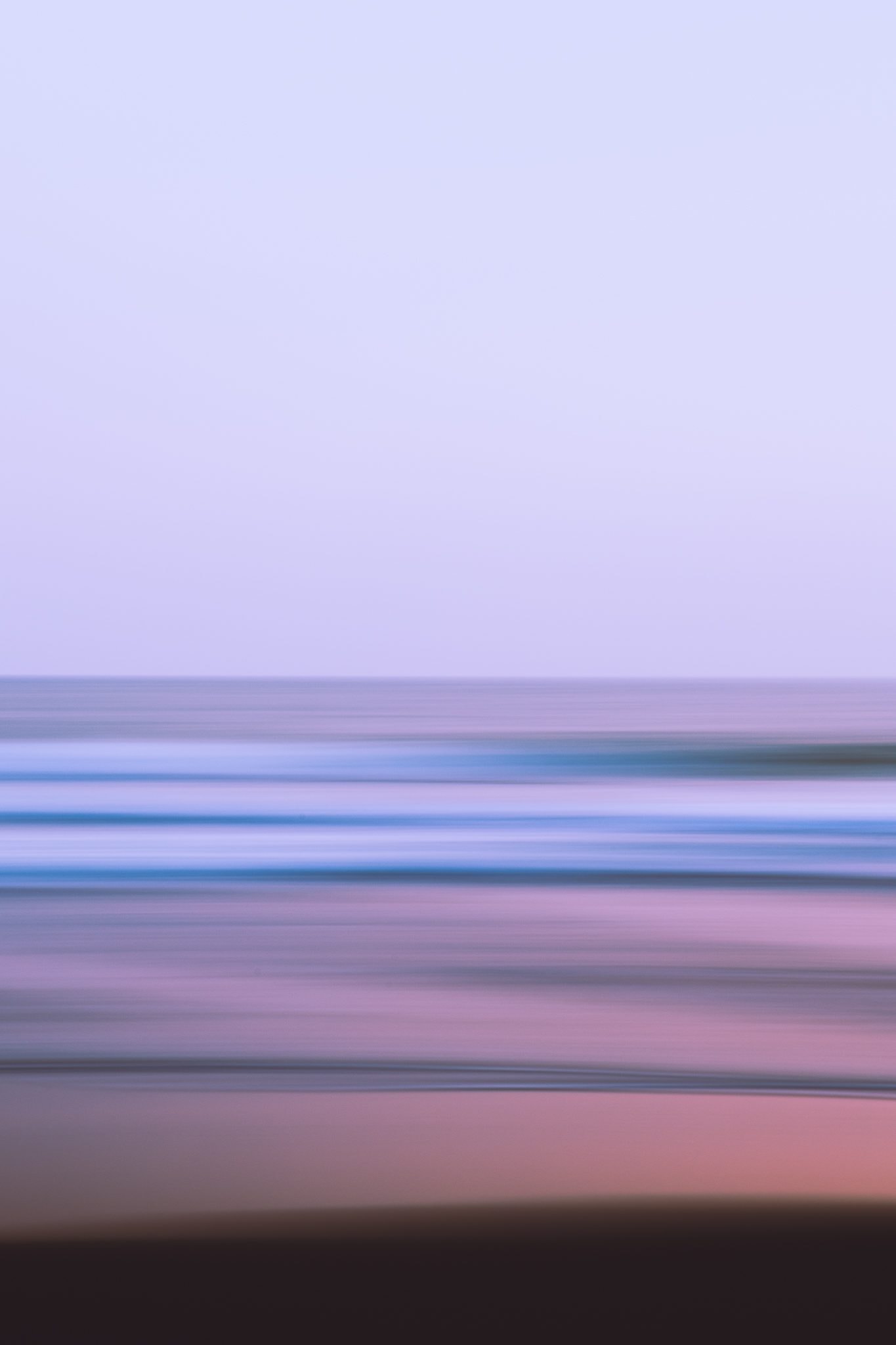 Long exposure abstracting sea and sky into pastel bands